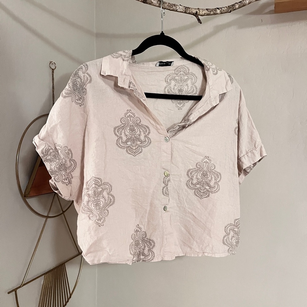 Cream cropped button down shirt with cuffed sleeves and notched collar